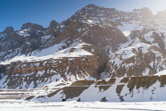 View of snow mountains and rugged rock formations under a clear sky, Pin Parvati Valley, Kaza, Spiti Valley, Himachal Pradesh, India.