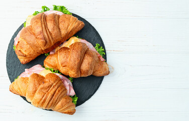 Croissant sandwich with salad ham and cheese . Top view