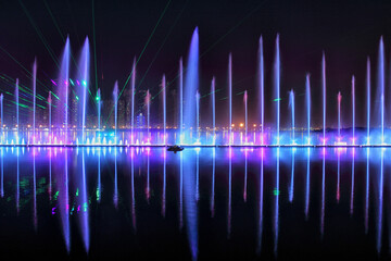 View of colorful illuminated fountain with vibrant lights and reflections, Dubai, United Arab Emirates.