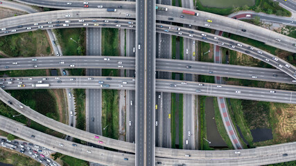 Aerial view elevated road traffic junctions, Modern construction design traffic ways traffic jams, Road interchange or highway intersection with busy urban traffic Junction network of transportation.