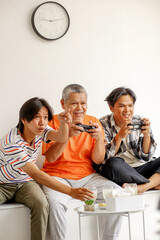 Asian Father And Son Have Fun And Playing Video Games Together At Home