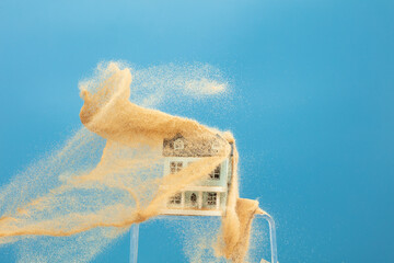 Sand storm hit House as natural disaster from climate change global warming. Strong wind of sand attack house with insurance create loss damage environment. Blue background isolated