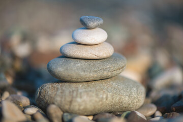 A pyramid of stones on a pebble beach by the sea, the concept of balance, balance, tranquility, relaxation