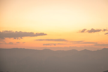 Silhouettes of mountains in a beautiful gentle haze, mountains at sunset or sunrise, natural background