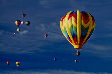 Naklejka premium Blue sky with cirrus clouds and hot air balloons colors and shapes. Concept of adventure, beginning of a new life, enchantment, wonder, growth, progress, success.
