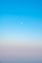 moon in the sky, Natural background, sky at sunrise or sunset, color gradient from pink orange to blue, delicate and smooth transition
