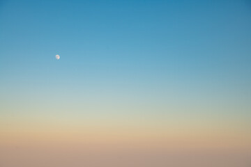 moon in the sky, Natural background, sky at sunrise or sunset, color gradient from pink orange to blue, delicate and smooth transition