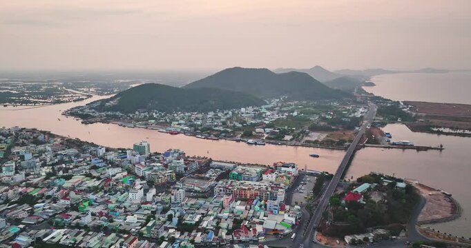 Top view aerial of Ha Tien City with development buildings, transportation, energy power infrastructure. Famous tourist city of Vietnam, sharing the border with Cambodia