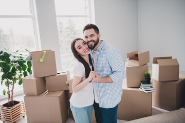 Photo of two young partners hold arms relocating moving box package new modern flat indoors