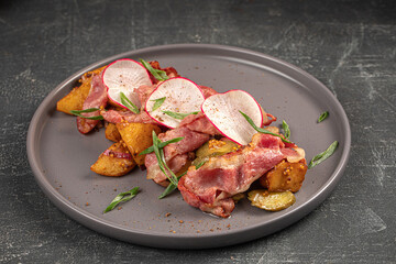 Portion of german salad with potato radish and bacon