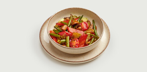 The salad is made with a mix of grilled vegetables, including cherry tomatoes, green beans, and mushrooms.