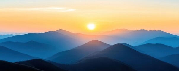 Obraz premium Sunrise over a mountain range, symbolizing the start of a new journey