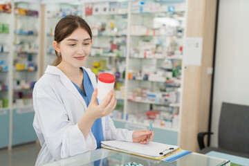 Pharmacist woman holding medicine jar in drugs shop pharmacy