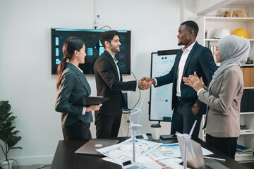 Successful Business Team in Office Cooperation, Professional Partnership Communication Highlighted as Colleagues Shake Hands and Collaborate, Teamwork Group Success in Corporate Setting