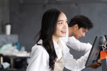 Friendly Small Business Owner Working Together in a Modern Cafe Setting
