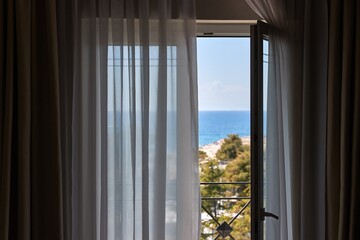 Fototapeta premium Apartment with sea view, open balcony door