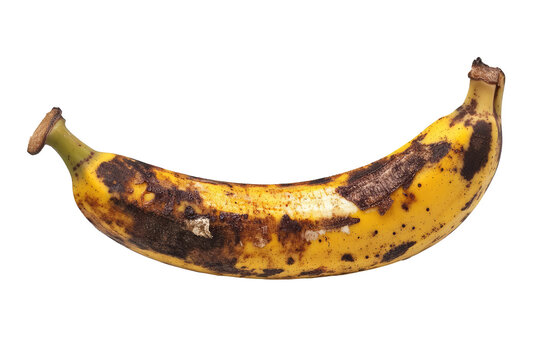 A close-up shot of a yellow banana that is heavily bruised and overripe, capturing the texture and detailing of the fruit as it progresses through its natural ripening process.