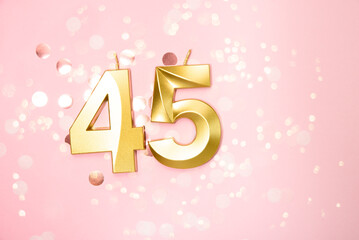 Number 45 forty five golden celebration birthday candle on Festive Background. forty five years birthday. concept of celebrating birthday, anniversary, important date, holiday