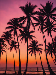 Coconut trees silhouetted against a sunset sky with pink and orange hues