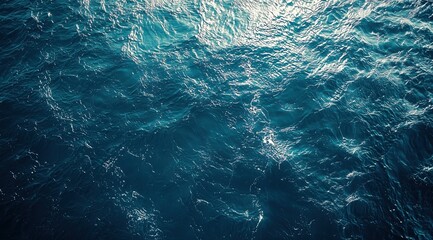 Fototapeta premium Dark blue ocean waves with white foam patterns.