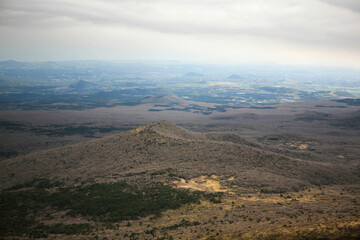 Fototapeta premium High-angle view of the small volcanoes and craters in Jeju Island
