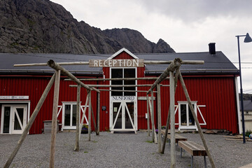 Typical Rourbuer fishing cabins in Lofoten Nusfjord village on a rainy day, summertime. Traditional norwegian red house