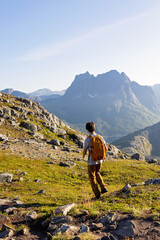 Naklejka premium Children and adults, family with dog, hiking Grytetippen trail in Senja, Lofoten on a sunny hot summer day