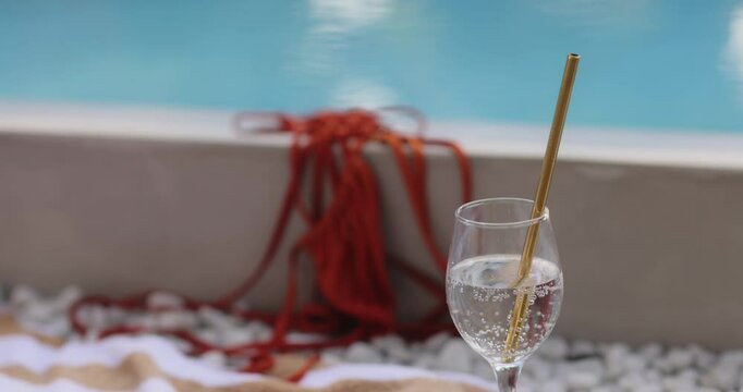 Refreshing Poolside Scene with Orange Bikini and Sparkling Drink