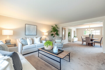 Fototapeta premium Bright, clean living room with neatly arranged furniture, a vacuumed carpet, and a spotless coffee table, exuding a sense of order and cleanliness.