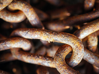 Backgrounds and textures: links of very old weathered rusty chain, close up shot, industrial...