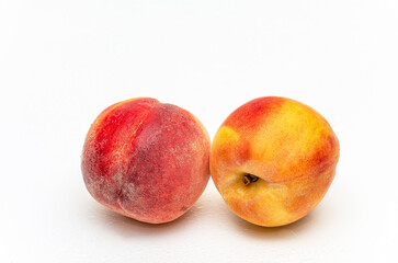 Two wet ripe peaches with water drops. Isolated on white background. Production juice. Copy space.