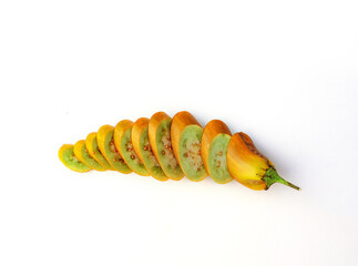 Yellow eggplant sliced ​​into slices on a white background.