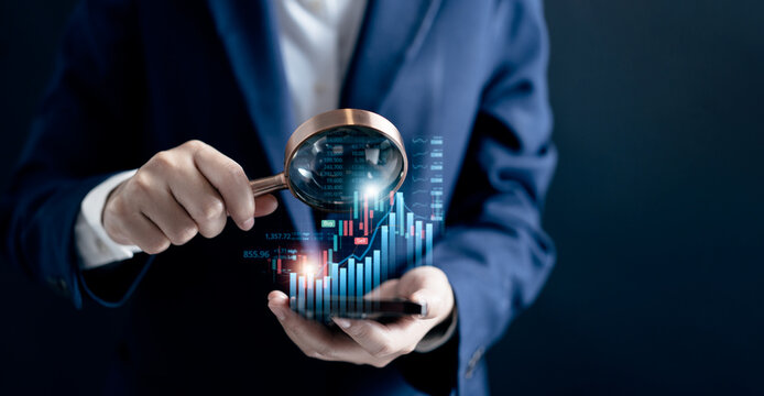 Businesswomen use magnifier glass find stock in stock markets, uptrends, growth economics, business strategy development, and opportunities for investment, take profit from funds, Financial Analyst.