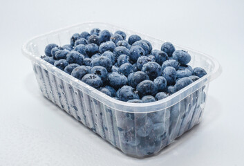 Side view box with fresh blueberries isolated on white. Concept of healthy eating. Weight loss.