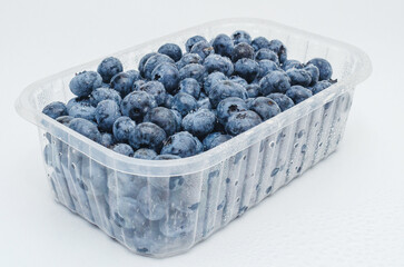 Side view box with fresh blueberries isolated on white. Concept of healthy eating. Weight loss.