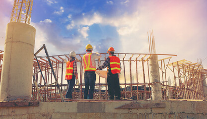 Structural engineer and architect and foreman worker with blueprints discuss, plan working for the...