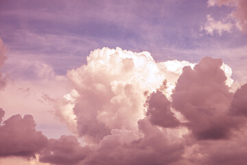 Magic pink fabulous cumulus clouds on blue sky at sunrise sunset nature background wallpaper