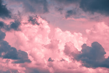 Magic pink fabulous cumulus clouds on blue sky at sunrise sunset nature background wallpaper