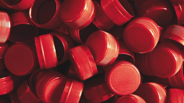 plastic bottle caps. Recycling collection and production processing plastic bottle caps background ,Industrial production of bottle caps made of red high-density polyethylene.