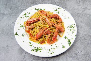 Tonnarello pasta con Gamberi rossi di Mazzara del Vallo is a typical Italian egg pasta cooked with red prawns from Mazzara del Vallo and cherry tomato pesto.