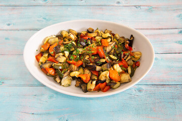 Caponata is a typical Sicilian dish in Italy made with aubergines, courgettes and fresh tomatoes.