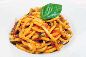 tonnarelli pomodoro e basilico or Tonnarelli egg pasta with tomato and basil is typical Italian dish