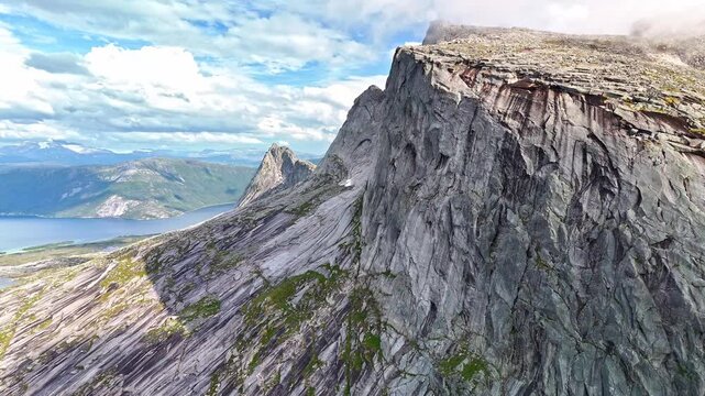 Clouds and fog rolling over mountain tops in Efjord in Northern Norway