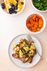 Stewed duck fillet with potatoes and asparagus and radishes, mixed salad of various greens, baked carrots in tahini sauce