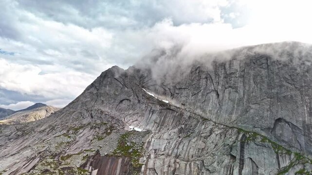 Clouds and fog rolling over mountain tops in Efjord in Northern Norway