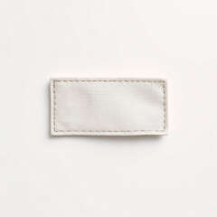 Minimalist cloth label mockup with no text, lying flat on a smooth white background