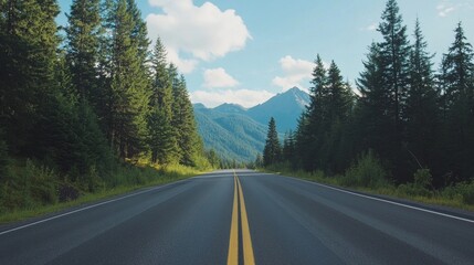 Fototapeta premium Road with pine trees and mountains in the background