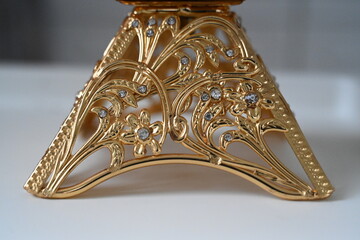 golden jewellery with small diamonds on it