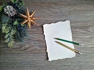 The Christmas letter, still empty, lies on the table, along with the crayons. Next to it is an...