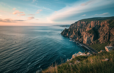 Majestic coastal cliffs at sunset with calm ocean waters